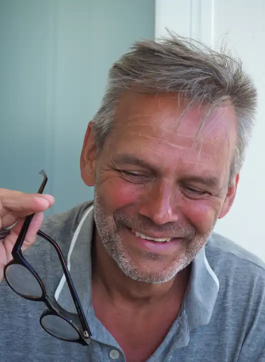 Older man tanned with glasses