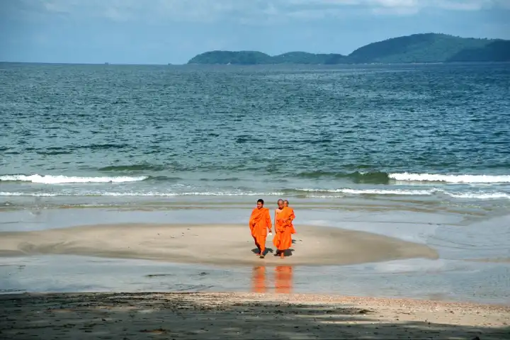 Buddhist monks at a beach of Chumporn Thailand