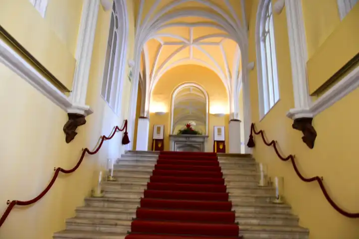 ornate staircase with red carpet in a castle in austria