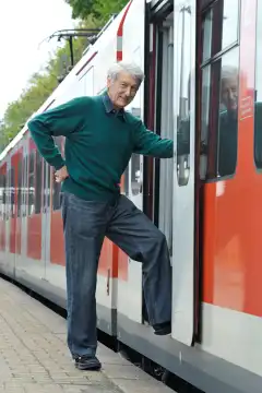 Senior, entering a train