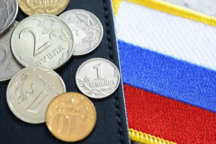 Ruble coins, flag of Russia and wallet