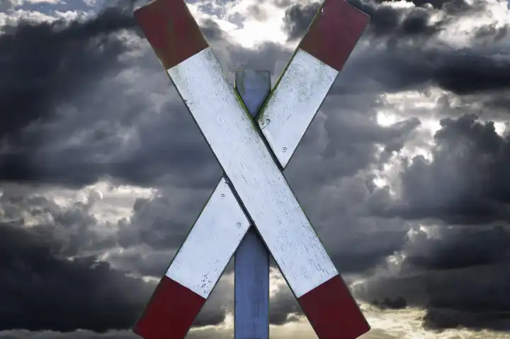 St. Andrews cross in front of dark sky, strike of the train drivers