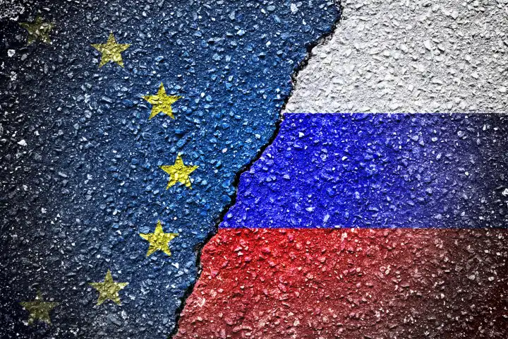 Flags of the EU and Russia on broken ground