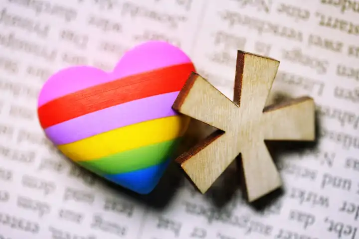 Gender star with heart in rainbow color on newspaper page, symbol photo gender language