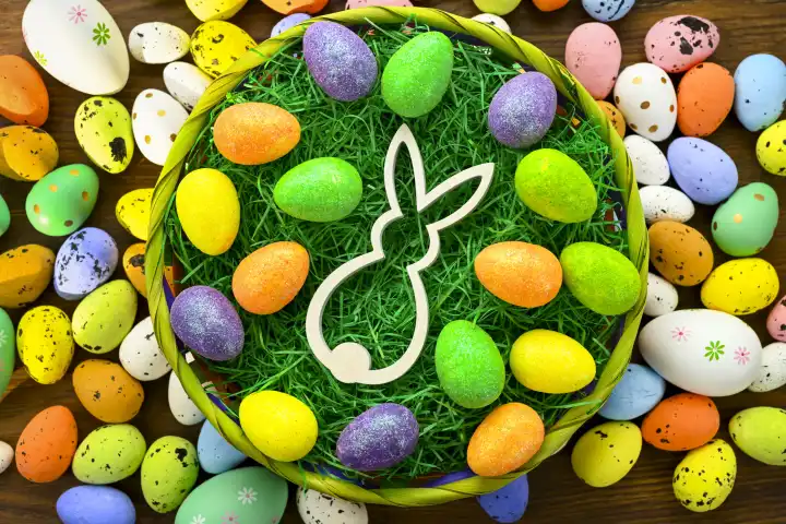 Easter bunny figurine and colorful Easter eggs in an Easter nest