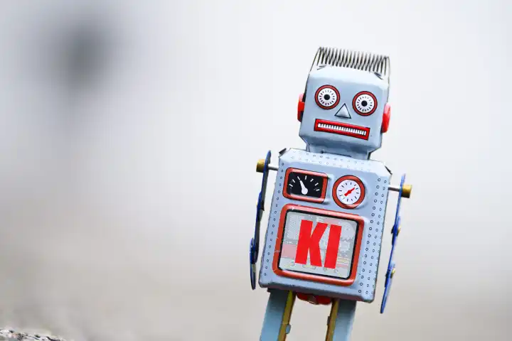 Roboterfigur mit Aufschrift KI, Fotomontage