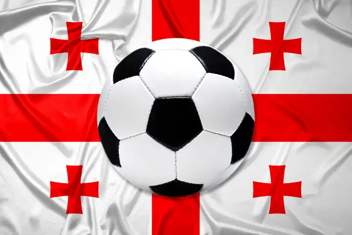 Schwarz-Weißer Lederfußball mit Fahne von Georgien, Fotomontage