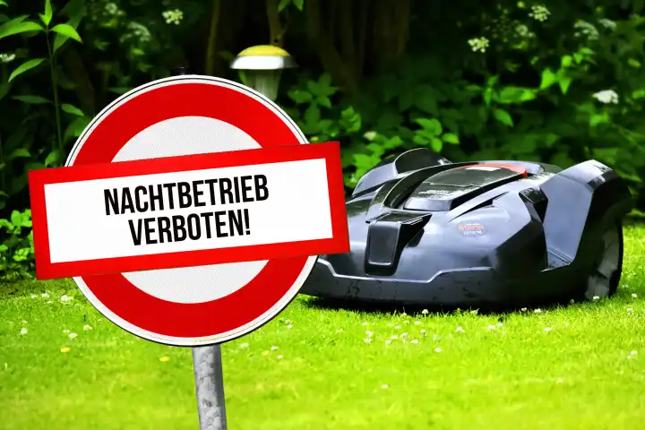 Robot mower on a lawn and sign saying night operation prohibited, photomontage
