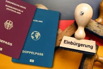 Stempel mit Aufschrift Einbürgerung auf deutscher Fahne und Doppelpass, Gesetz zur Modernisierung des Staatsangehörigkeitsrechts, Fotomontage