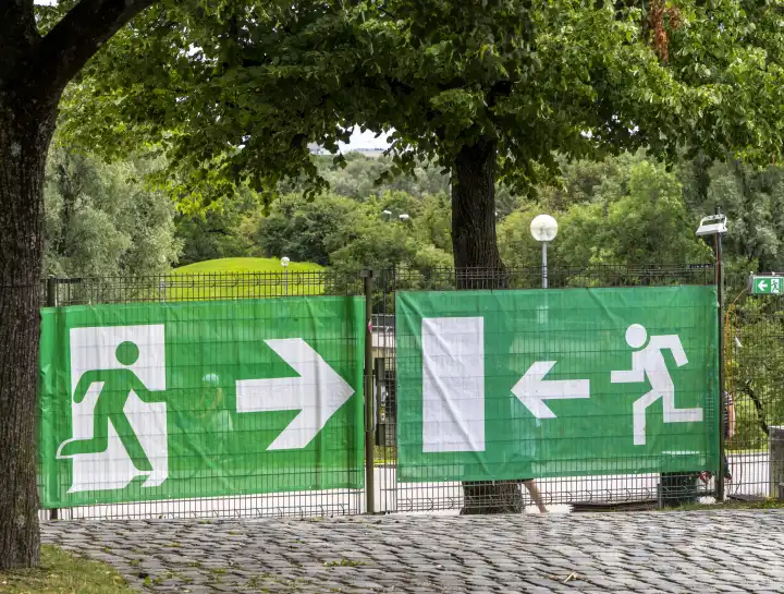 Construction fence with sign for escape route, Munich, Bavaria, Germany