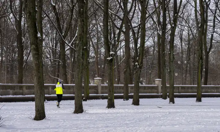 Winter, Jogger with yellow protective clothing , Berlin, Germany