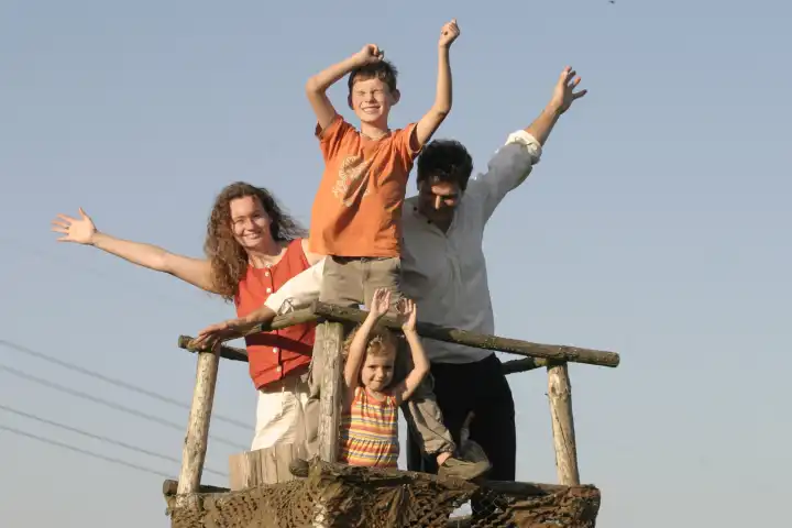 Happy Family waving down from Raised Stand