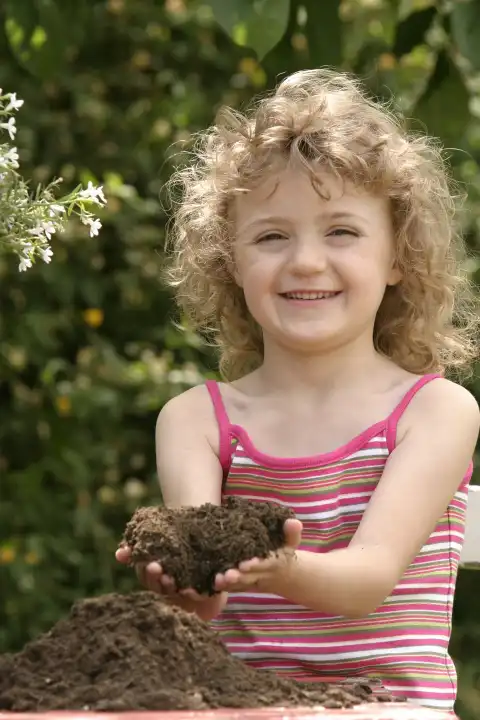 Girl Holding Potting Soil