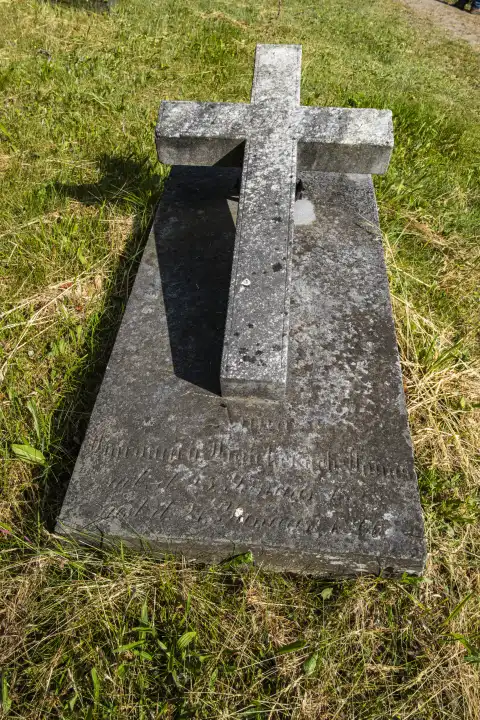 Grave slab with cross, historical Protestant cemetery Bad Carlsruhe (Pokoj), district Namslau (Namyslow), voivodeship Oppeln, Upper Silesia, Poland.