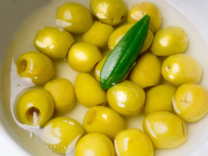 Pitted edible olives in a small bowl