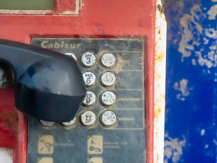 Old, weathered payphone with keypad