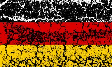 Germany flag on dissolving paint, defective concrete. Cracked Effect and Cracks