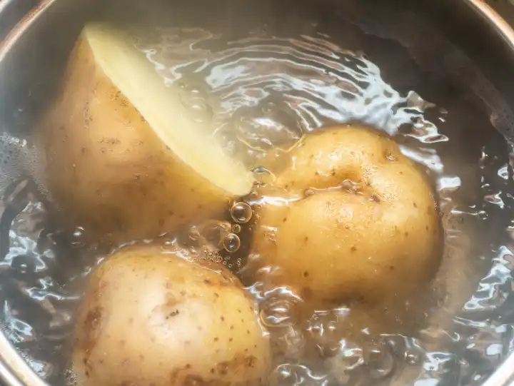 Boil potatoes with skin in a pot