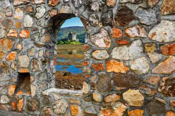 View of Eilean Castle in Scotland through a window of a historic wall