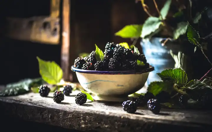 Blackberries in a bowl in a rustic setting, AI generated