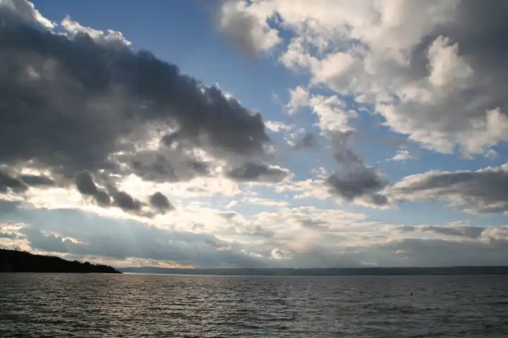 dynamic cloudy sky with clouds above a lake called ammersee in bavaria