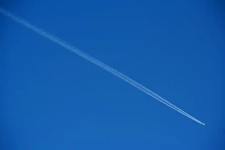 airplane at the sky with white contrail