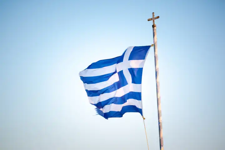 An image of the greek flag under a blue sky