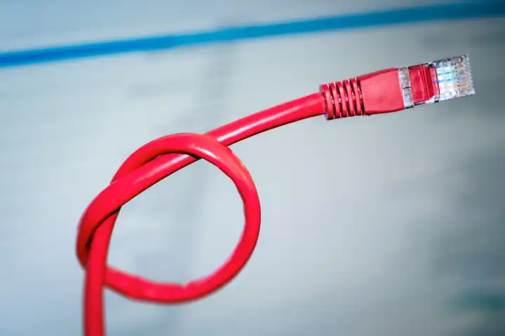 An image of a red networking cable with a knot