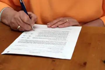 A woman fills out a form