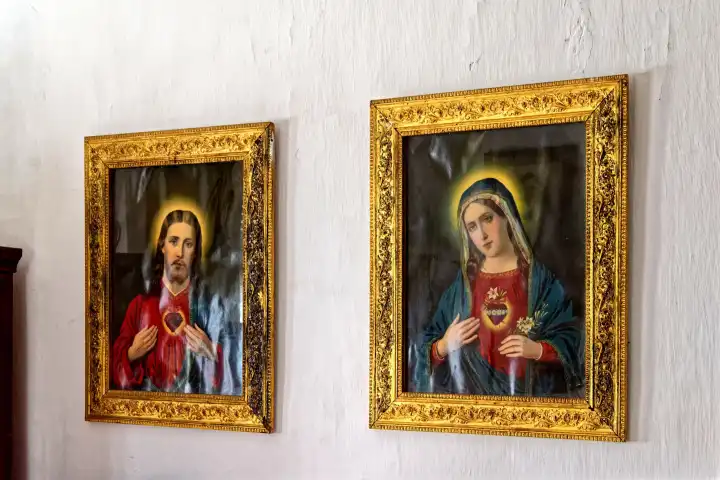 Holy images of Jesus and Mary hung in frame