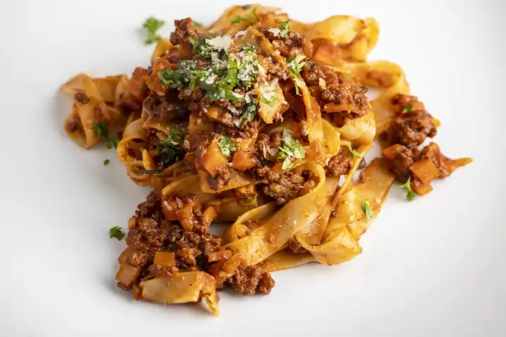 Tagliatelle pasta with bolognese on a white plate