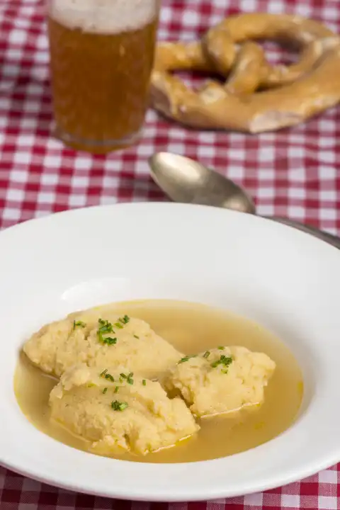 Bavarian dumpling soup on tablecloth 
