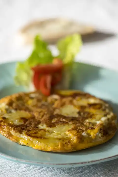 Tortilla Española on a plate of tomatoes 