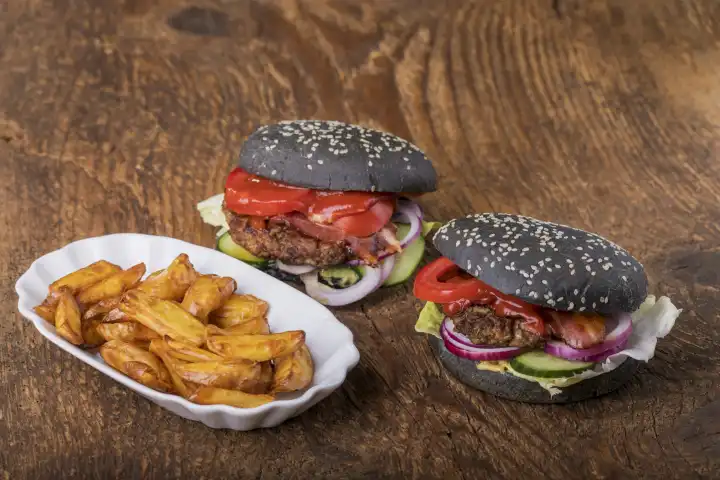 Close-up of black hamburgers on wood 