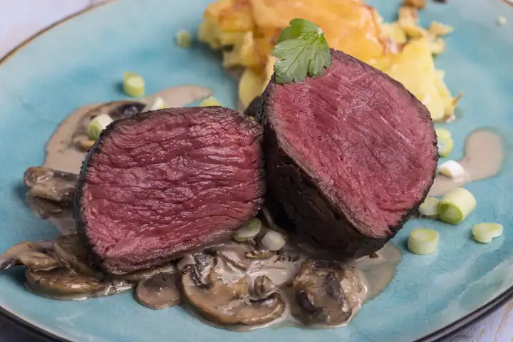 Cut steak and potato gratin on a plate 