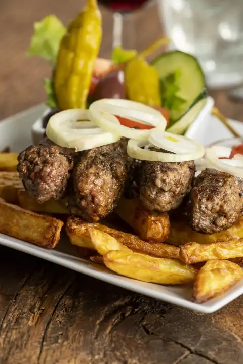 Cevapcici with fries and onion rings 
