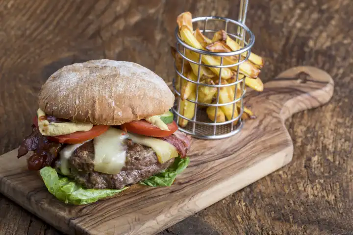 Cheeseburger with fries on wood 