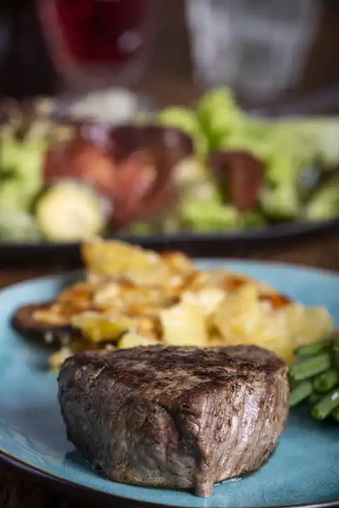 Steak with potato gratin and salad