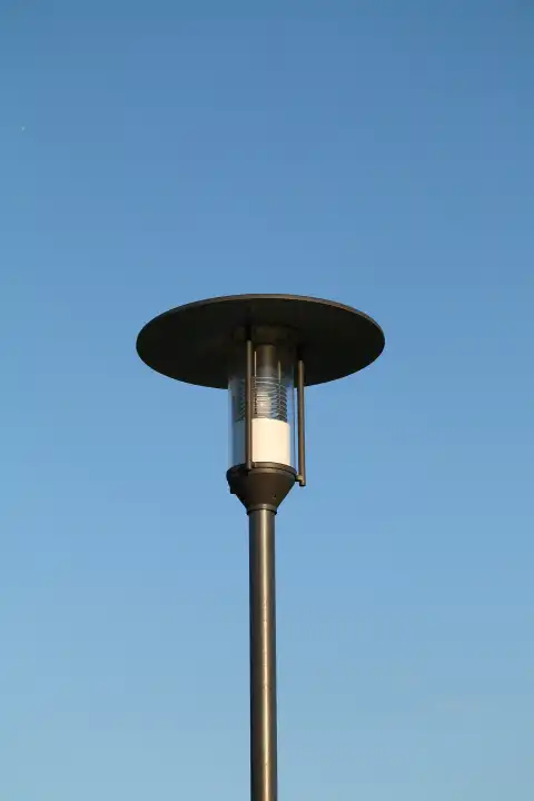 Classic street lamp against a blue sky