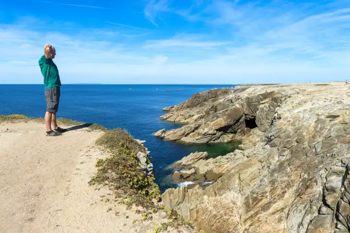 Lonely man standing on the cliff of Quiberon island