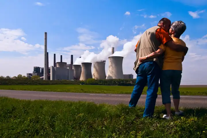 couple in love in front of a brown coal power plant