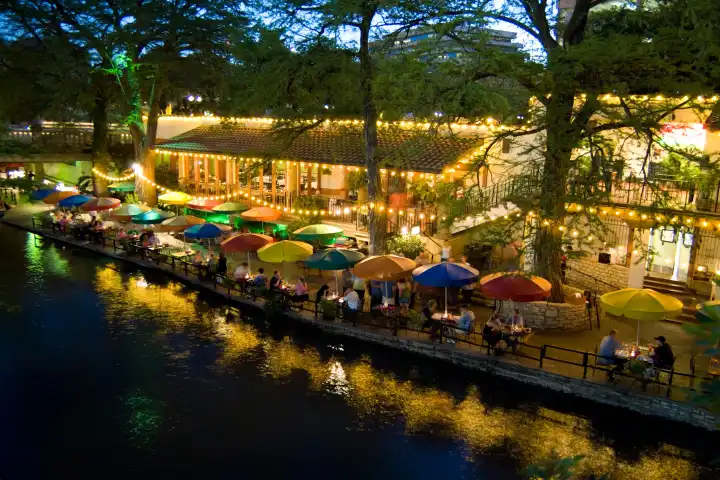 Famous River Walk restaurants and cafes of Casa Rio on water on holiday tourists in San Antonio Texas USA