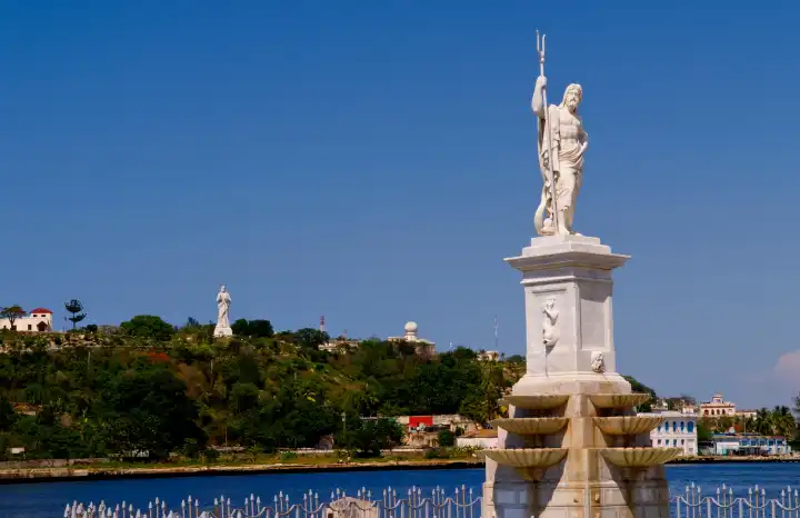River and statues with Christ statue on hill in background in Havana Cuba Habana