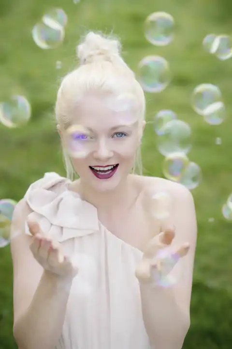 young, blond woman with soap bubbles