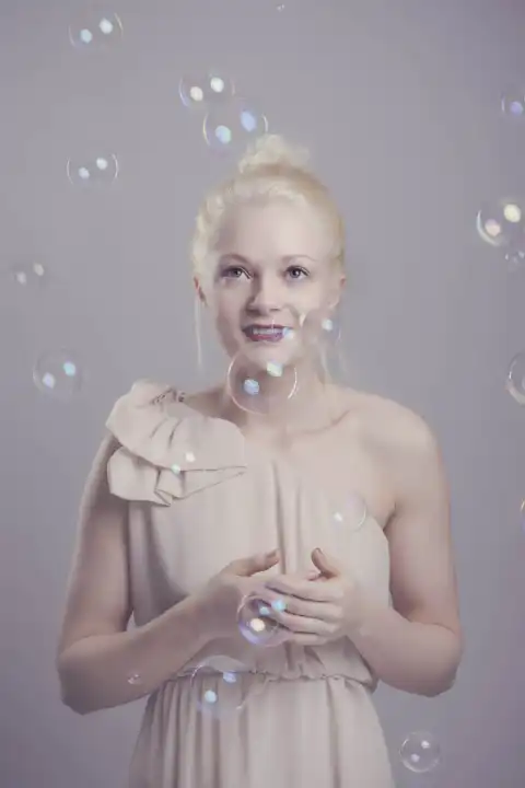 young, blond woman with soap bubbles