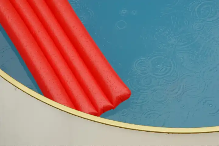 Red airbed in a pool