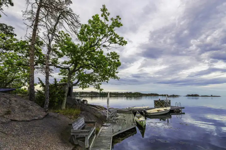 Baltic Sea coast with jetty and boats near Oskarshamn in Sweden.