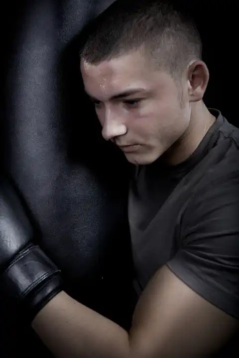 portrait of a young boxer in front of dark background