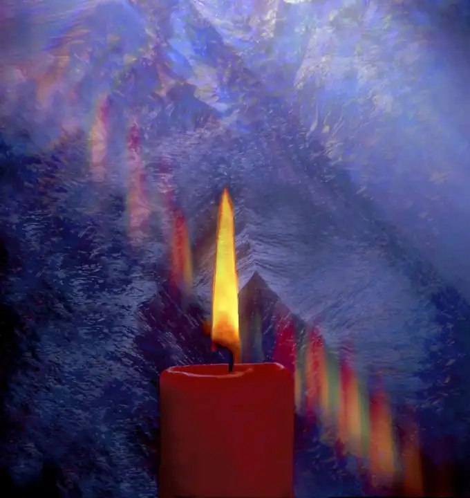 burning candle in front of icy window advent christmas light