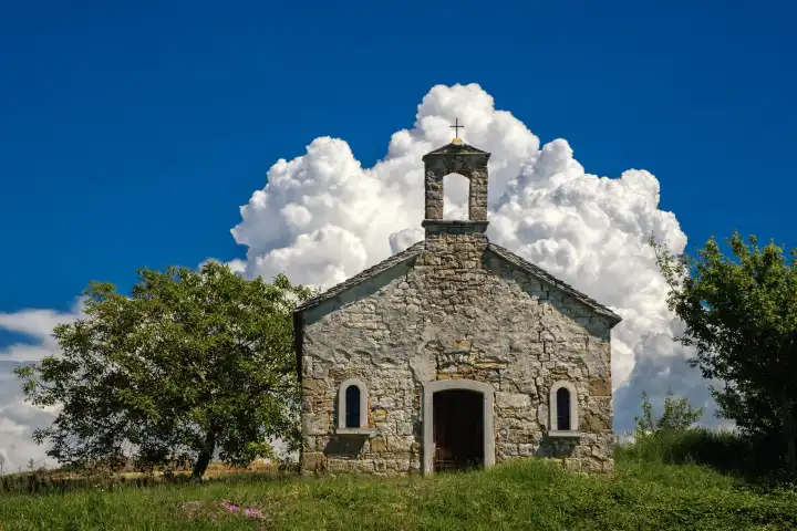 stone chapel in front of cumulus cloud